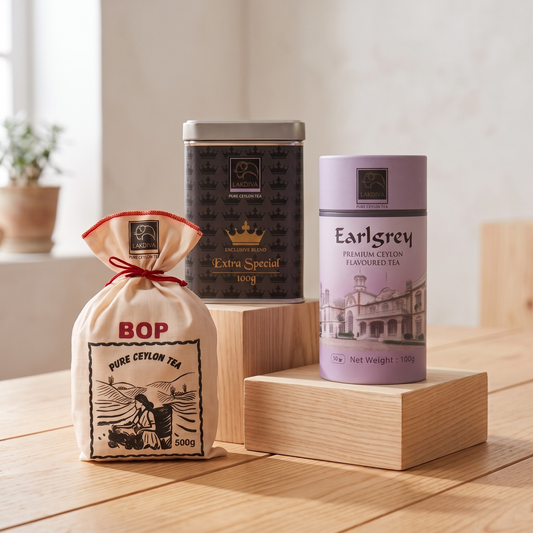 Three Ceylon tea products displayed on wooden blocks in a bright indoor setting: a beige drawstring pouch labeled BOP Pure Ceylon Tea, a dark metal tin labeled Extra Special, and a lavender cylindrical tin labeled Earl Grey Premium Ceylon Flavoured Tea.